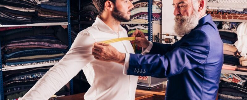 Styliste professionnel prenant la mesure de la poitrine de son client. Les meilleurs magasins de vêtements pour hommes en France