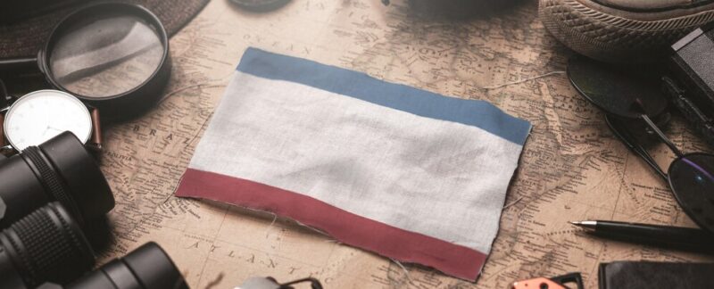 Crimea Flag Between Traveler's Accessories on Old Vintage Map. Destinations touristiques.meilleures curiosités sur la France